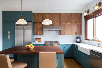 Inspiration for a contemporary l-shaped kitchen in San Francisco with a farmhouse sink, recessed-panel cabinets, medium wood cabinets, quartz benchtops, multi-coloured splashback, engineered quartz splashback, stainless steel appliances, medium hardwood floors, with island and multi-coloured benchtop.