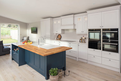 Inspiration for a country open plan kitchen in Dublin with light hardwood floors and with island.