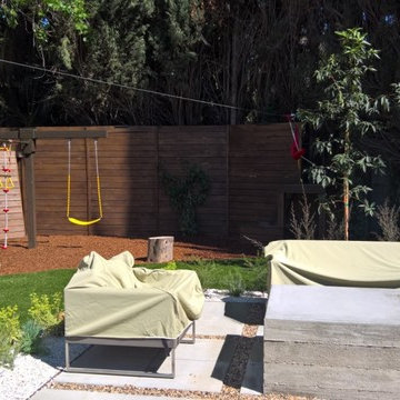 backyard with play structure, fire pit table and new patio