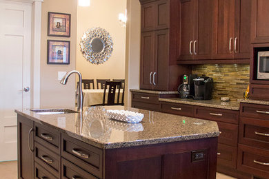 Inspiration for a mid-sized transitional l-shaped enclosed kitchen remodel in Other with an undermount sink, recessed-panel cabinets, medium tone wood cabinets, granite countertops, stainless steel appliances and an island