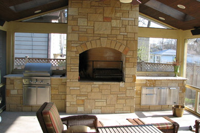Example of a large classic backyard brick patio design in Chicago with a fire pit and a pergola