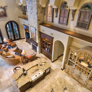 Ejemplo de salón abierto, mediterráneo, extra grande, con suelo de travertino, chimenea tradicional, marco de chimenea de piedra y pared multimedia