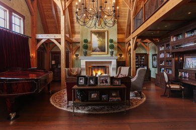 Example of a large classic dark wood floor and brown floor home office library design in Other with a stone fireplace, green walls and a standard fireplace