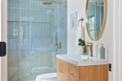 Example of a beach style porcelain tile and single-sink bathroom design in Boston with quartzite countertops and a floating vanity