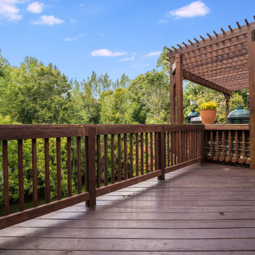 Expansive Wood Deck with Pergola and Forest Views