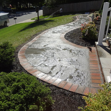 Irregular flagstone walkway with a brick border.