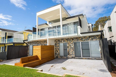 Photo of a large balcony in Central Coast with no cover and glass railing.