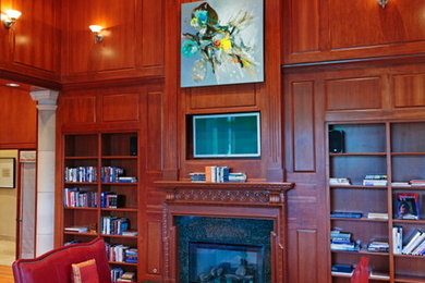 Family room library - huge traditional open concept medium tone wood floor family room library idea in Denver with a standard fireplace, a wood fireplace surround and a media wall