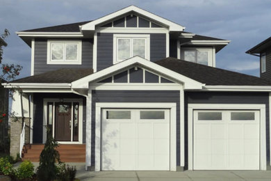 Large elegant blue two-story concrete fiberboard exterior home photo in Other with a hip roof