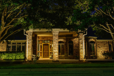 Example of a mid-sized one-story brick house exterior design