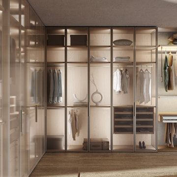 Walk in Closet Featuring Tall Glass Framed Cabinets