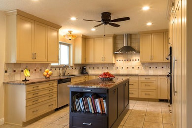 Eat-in kitchen - large transitional u-shaped ceramic tile eat-in kitchen idea in Orange County with an undermount sink, shaker cabinets, white cabinets, granite countertops, beige backsplash, ceramic backsplash, stainless steel appliances and an island