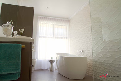 Design ideas for a large modern master bathroom in Perth with a vessel sink, flat-panel cabinets, grey cabinets, a freestanding tub, an open shower, a one-piece toilet, white tile, ceramic tile, white walls and ceramic floors.