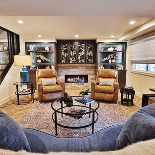 Diseño de sótano con puerta de estilo zen, de tamaño medio, con paredes blancas, suelo de baldosas de porcelana, chimenea tradicional, marco de chimenea de piedra y suelo marrón