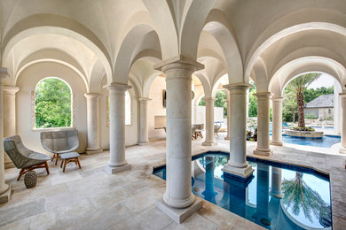 Tuscan backyard tile and custom-shaped lap pool photo in Houston