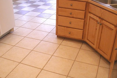 Inspiration for a craftsman single-wall ceramic tile open concept kitchen remodel in Orange County with a double-bowl sink, raised-panel cabinets, medium tone wood cabinets, solid surface countertops, brown backsplash, black appliances and no island
