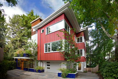 Design ideas for a large contemporary three-storey red exterior in Boston with wood siding.