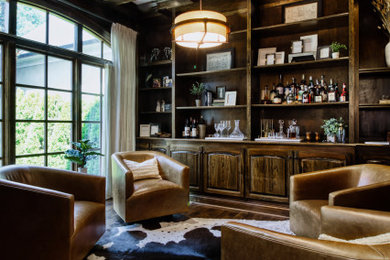Example of a mid-sized tuscan single-wall dark wood floor and brown floor dry bar design in Nashville with raised-panel cabinets, dark wood cabinets, wood countertops, wood backsplash and brown countertops