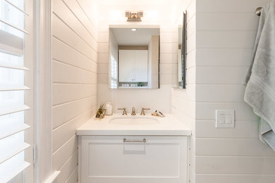 Bathroom - mid-sized transitional kids' beige tile and stone tile limestone floor bathroom idea in Miami with shaker cabinets, white cabinets, white walls, an undermount sink and quartz countertops