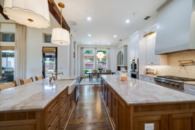 Inspiration for a transitional kitchen remodel in Dallas with shaker cabinets, quartzite countertops and two islands
