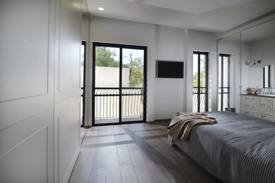 Large contemporary guest bedroom in Tel Aviv with white walls, plywood floors and no fireplace.