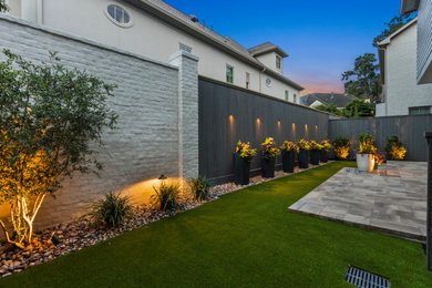 This is an example of a small modern backyard stone landscaping in Houston.