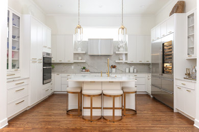 Inspiration for a large transitional medium tone wood floor and brown floor eat-in kitchen remodel in Other with an undermount sink, recessed-panel cabinets, white cabinets, quartzite countertops, gray backsplash, quartz backsplash, stainless steel appliances, an island and white countertops