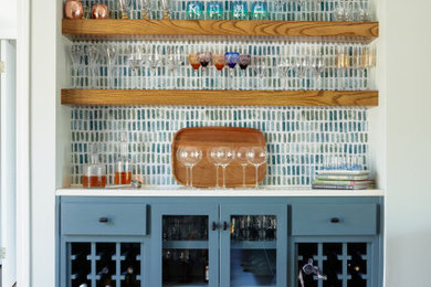 Dry bar - transitional single-wall dry bar idea in Kansas City with floating shelves and blue cabinets