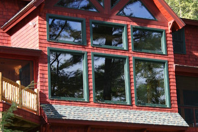 Inspiration for a large rustic red two-story wood gable roof remodel in Boston