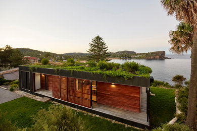 Photo of a contemporary exterior in Sydney with wood siding.