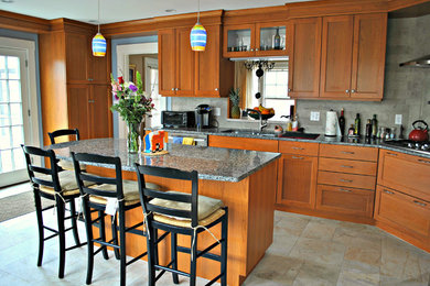 Mid-sized eclectic l-shaped slate floor and gray floor eat-in kitchen photo in Boston with a double-bowl sink, shaker cabinets, medium tone wood cabinets, granite countertops, gray backsplash, stone tile backsplash, stainless steel appliances and an island