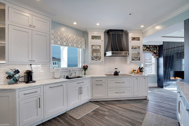 Beach style eat-in kitchen photo in Other with a single-bowl sink, shaker cabinets, white cabinets, white backsplash, subway tile backsplash, stainless steel appliances, an island and multicolored countertops