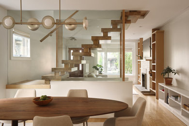 Inspiration for a mid-sized scandinavian dining room remodel in Toronto with a standard fireplace and a brick fireplace