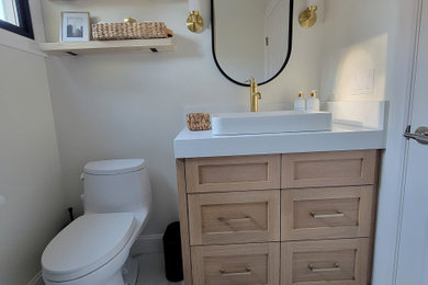Inspiration for a mid-sized rustic 3/4 white tile and porcelain tile ceramic tile, white floor and single-sink wet room remodel in San Francisco with shaker cabinets, light wood cabinets, a one-piece toilet, white walls, a vessel sink, quartzite countertops, a hinged shower door, white countertops and a built-in vanity