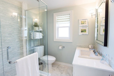 Corner shower - small transitional 3/4 white tile and mosaic tile marble floor corner shower idea in Toronto with shaker cabinets, white cabinets, a one-piece toilet and a drop-in sink