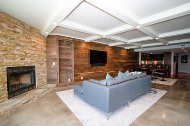 Photo of a large contemporary formal open concept living room in Orange County with multi-coloured walls, concrete floors, a standard fireplace, a stone fireplace surround, a wall-mounted tv and grey floor.