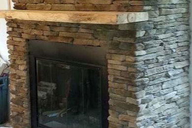 Elegant family room photo in New York with a standard fireplace and a stone fireplace