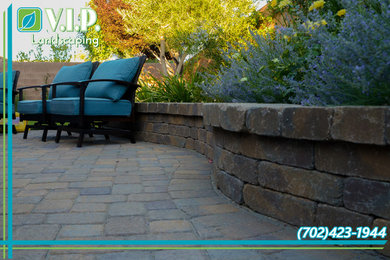Photo of a mid-sized traditional full sun backyard concrete paver landscaping in Las Vegas.