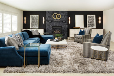 Large trendy walk-out concrete floor and white floor basement photo in DC Metro with a bar, black walls, a standard fireplace and a stone fireplace