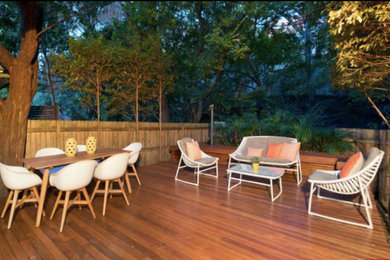 This is an example of a mid-sized traditional backyard deck in Sydney with no cover.