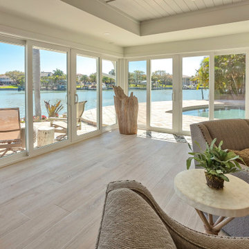 Indoor Lounge With Wall-to-Wall Pool Views and Seamless Outdoor Transition