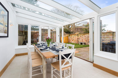 Design ideas for a medium sized scandinavian dining room in Kent with a standard fireplace and a brick fireplace surround.