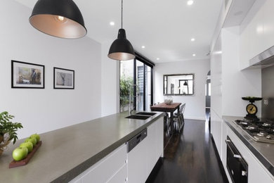 Design ideas for a contemporary kitchen in Sydney with a double-bowl sink, concrete benchtops, grey splashback and stainless steel appliances.