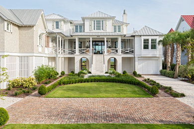 Example of a huge beach style white three-story mixed siding and clapboard house exterior design in Charleston with a hip roof, a mixed material roof and a gray roof