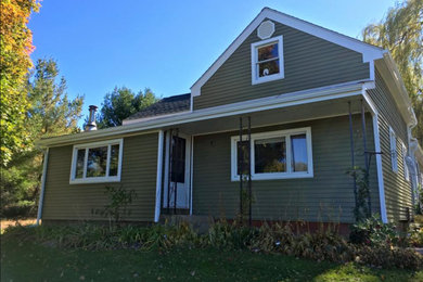 Example of a small classic green one-story wood house exterior design in New York