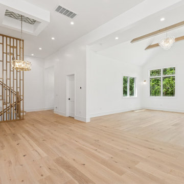 Symmetrical Custom Built-Ins Framing Sculptural Staircase