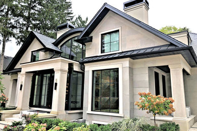 Example of a large transitional white two-story stone exterior home design in Toronto with a mixed material roof and a black roof