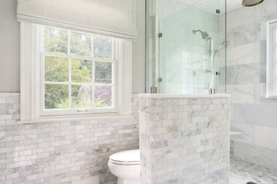 Example of a mid-sized eclectic master gray tile and marble tile marble floor, gray floor, double-sink and wainscoting double shower design in Philadelphia with shaker cabinets, gray cabinets, a two-piece toilet, gray walls, an undermount sink, marble countertops, a hinged shower door, white countertops and a freestanding vanity