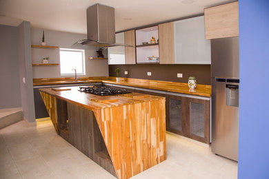 Inspiration for a mid-sized contemporary l-shaped ceramic tile enclosed kitchen remodel in Other with glass-front cabinets, brown cabinets, wood countertops, brown backsplash and an island