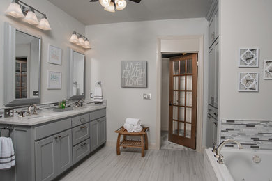 Photo of a mid-sized contemporary master bathroom in Other with shaker cabinets, grey cabinets, an alcove tub, multi-coloured tile, matchstick tile, white walls, porcelain floors, an undermount sink, engineered quartz benchtops and grey floor.